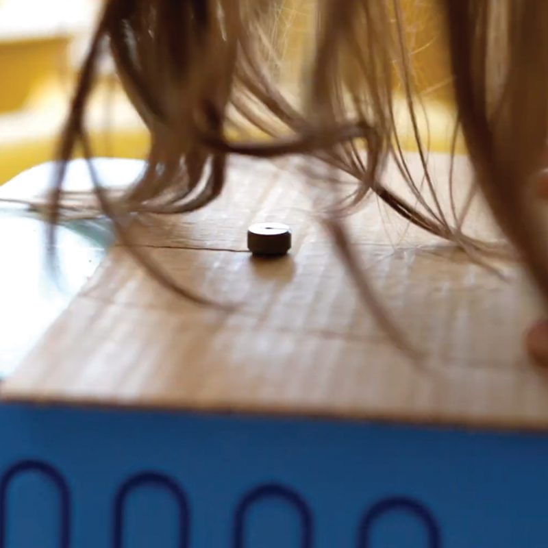 Close-up of the ChompSaw cutting a cardboard sheet