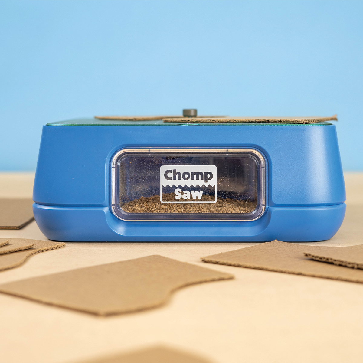 ChompSaw ChompSaw kid-safe cardboard cutter, front view with cut cardboard pieces