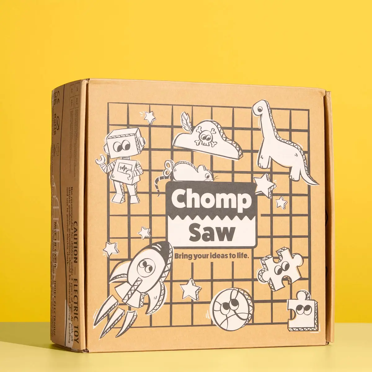 ChompSaw retail box art with rocket, robot and dinosaur cardboard illustrations