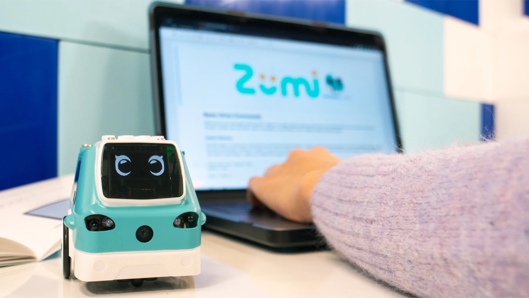 Zumi self-driving car kit beside a laptop running its lessons