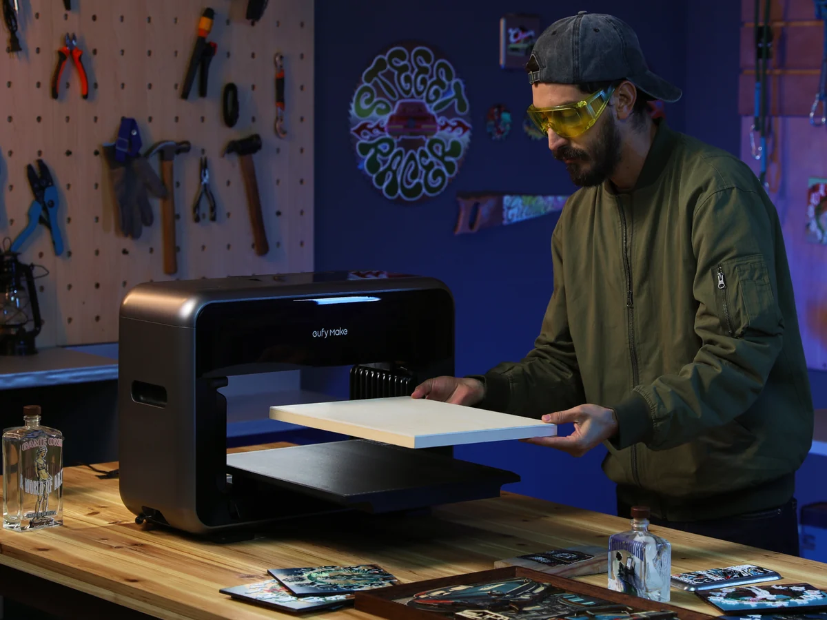 Loading a board into the eufyMake E1 in a workshop